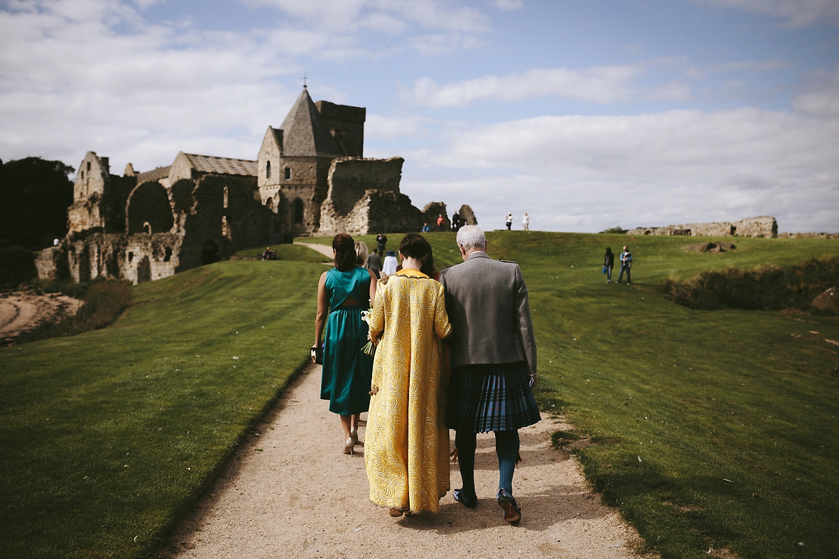 31 A yellow 1970s vintage Christian Dior gown and cape for a modern alternative Scottish wedding