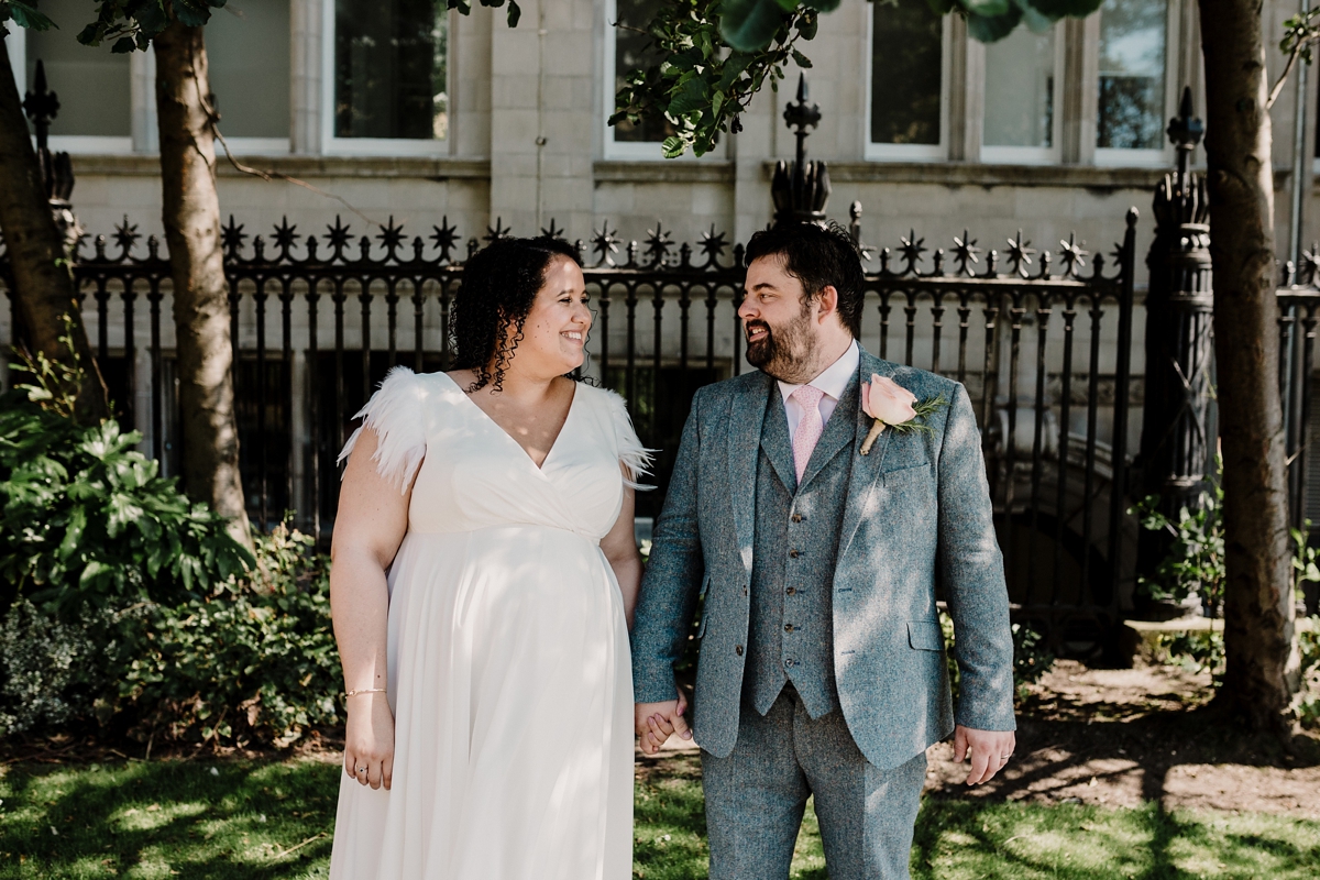 36 A pregnant bride wearing a feather cap sleeved Halfpenny London dress