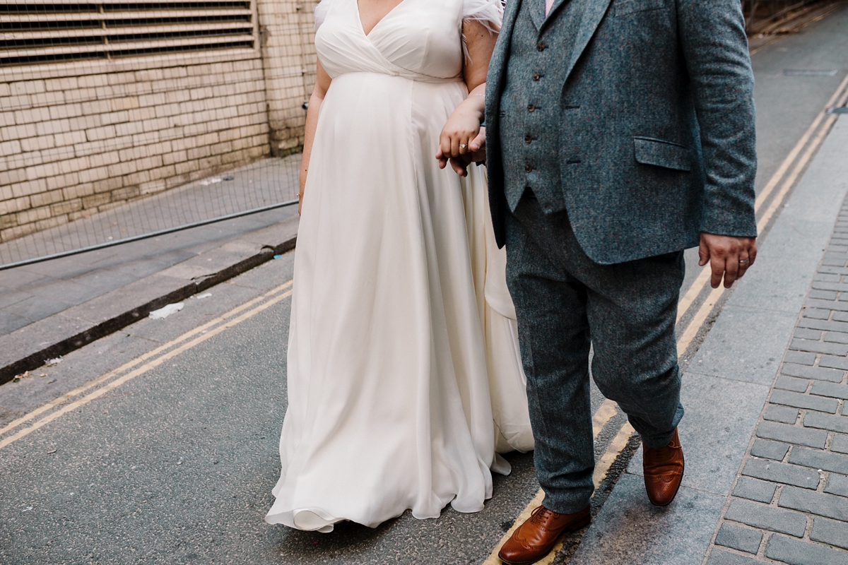 39 A pregnant bride wearing a feather cap sleeved Halfpenny London dress
