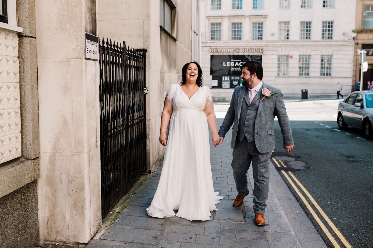 42 A pregnant bride wearing a feather cap sleeved Halfpenny London dress