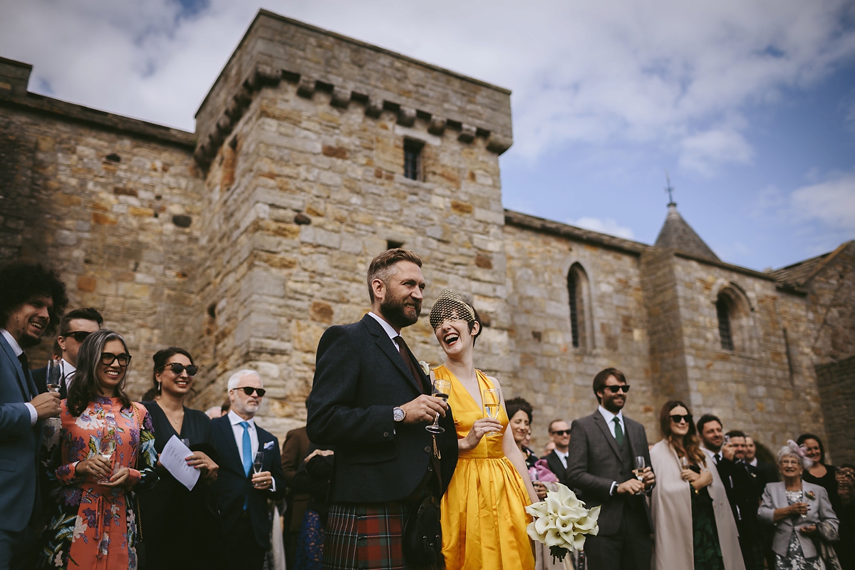 42 A yellow 1970s vintage Christian Dior gown and cape for a modern alternative Scottish wedding
