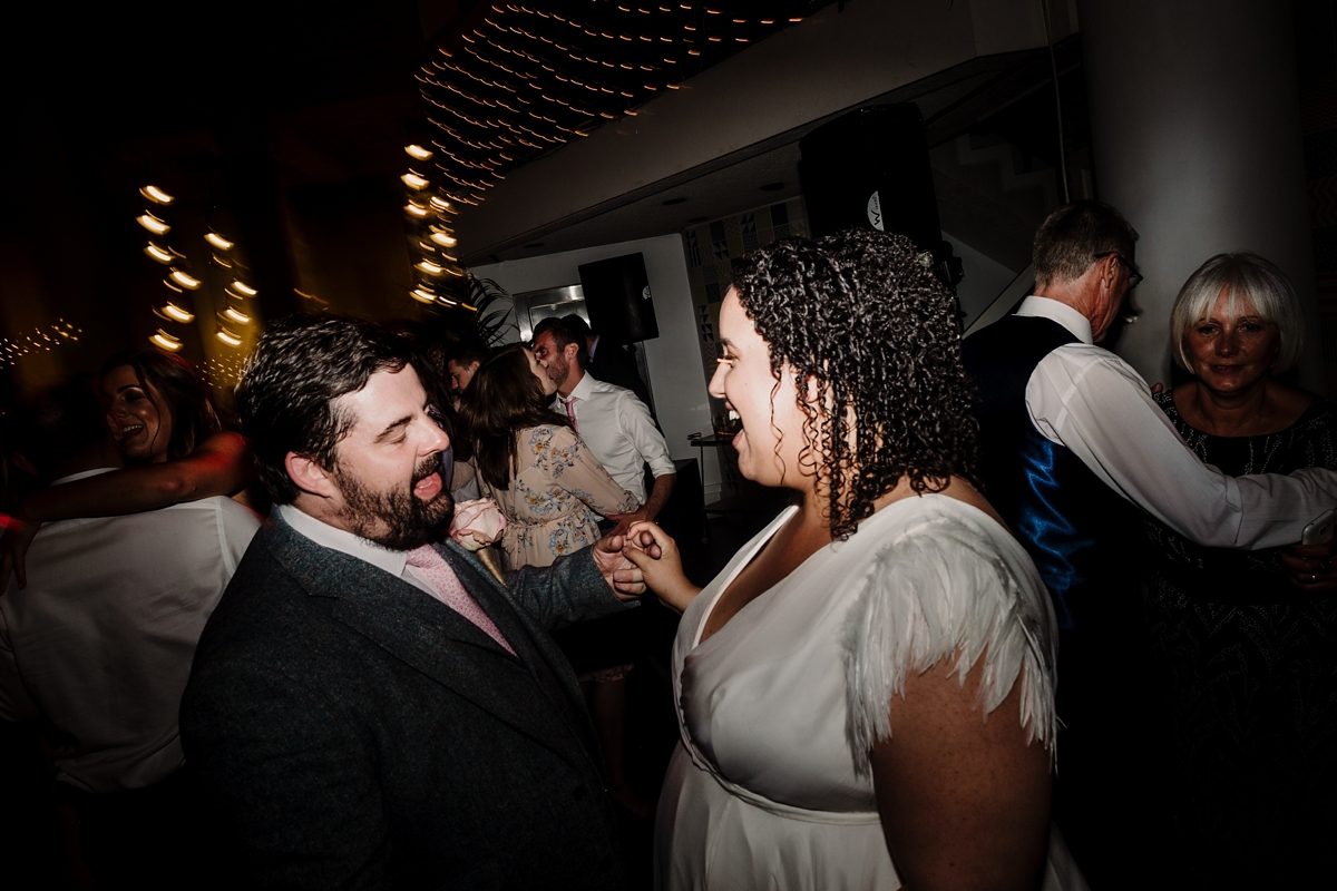 53 A pregnant bride wearing a feather cap sleeved Halfpenny London dress