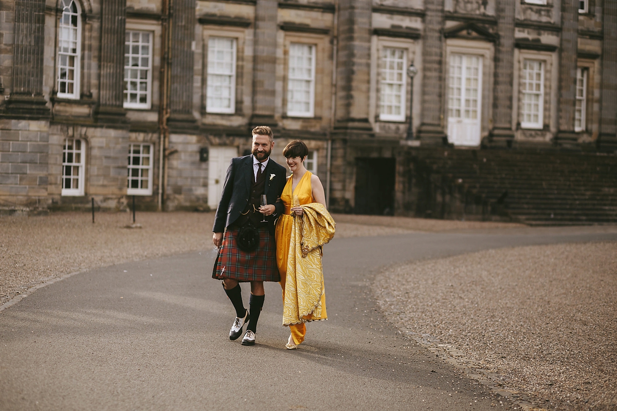 65 A yellow 1970s vintage Christian Dior gown and cape for a modern alternative Scottish wedding