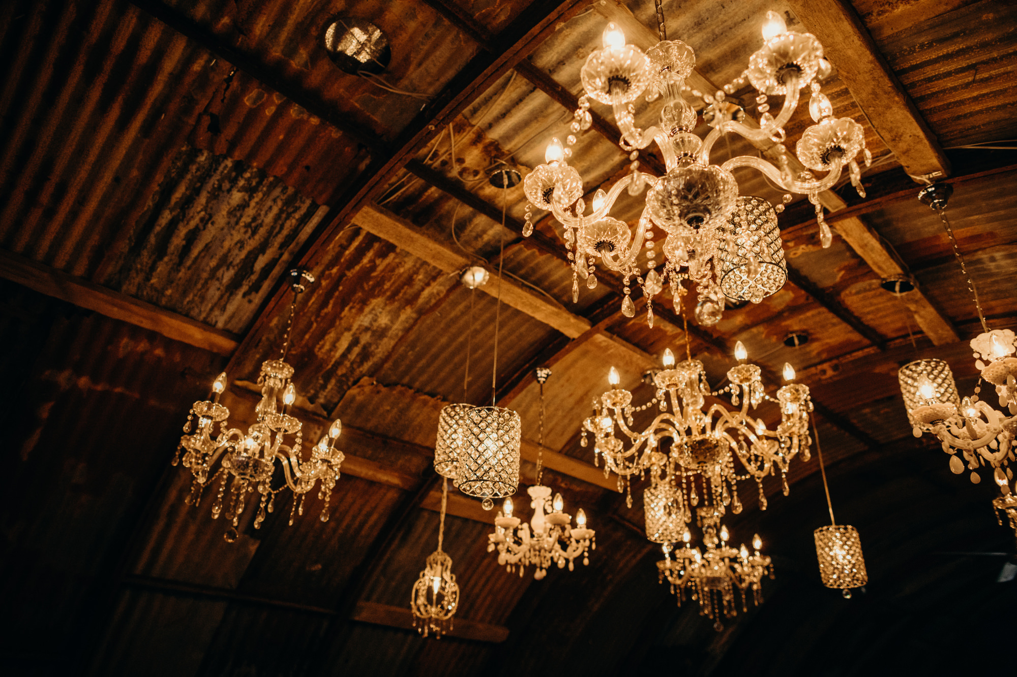 01 Chandeliers hanging from a barn for a wedding reception