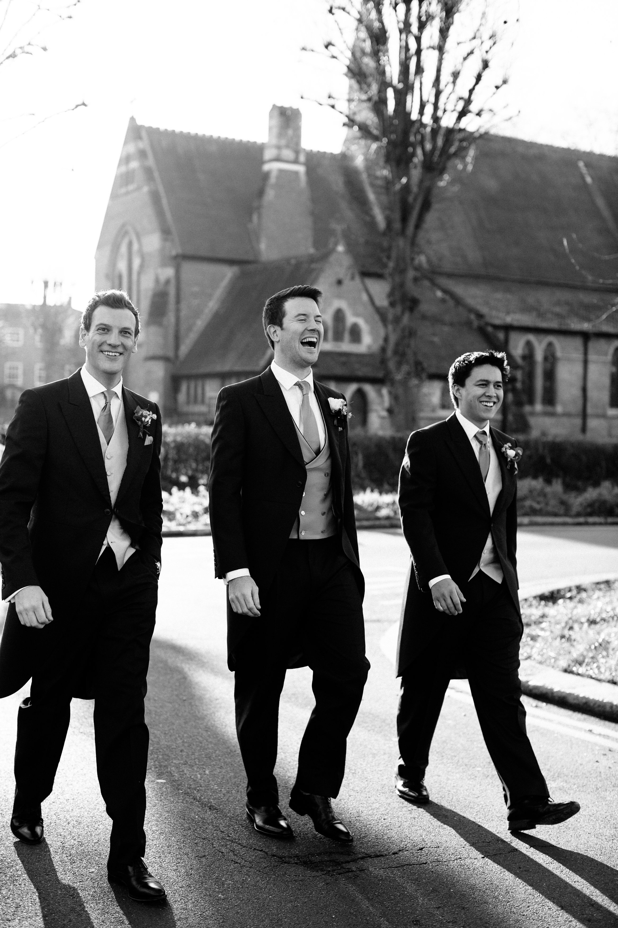 Groomsmen in tails on the way to the church