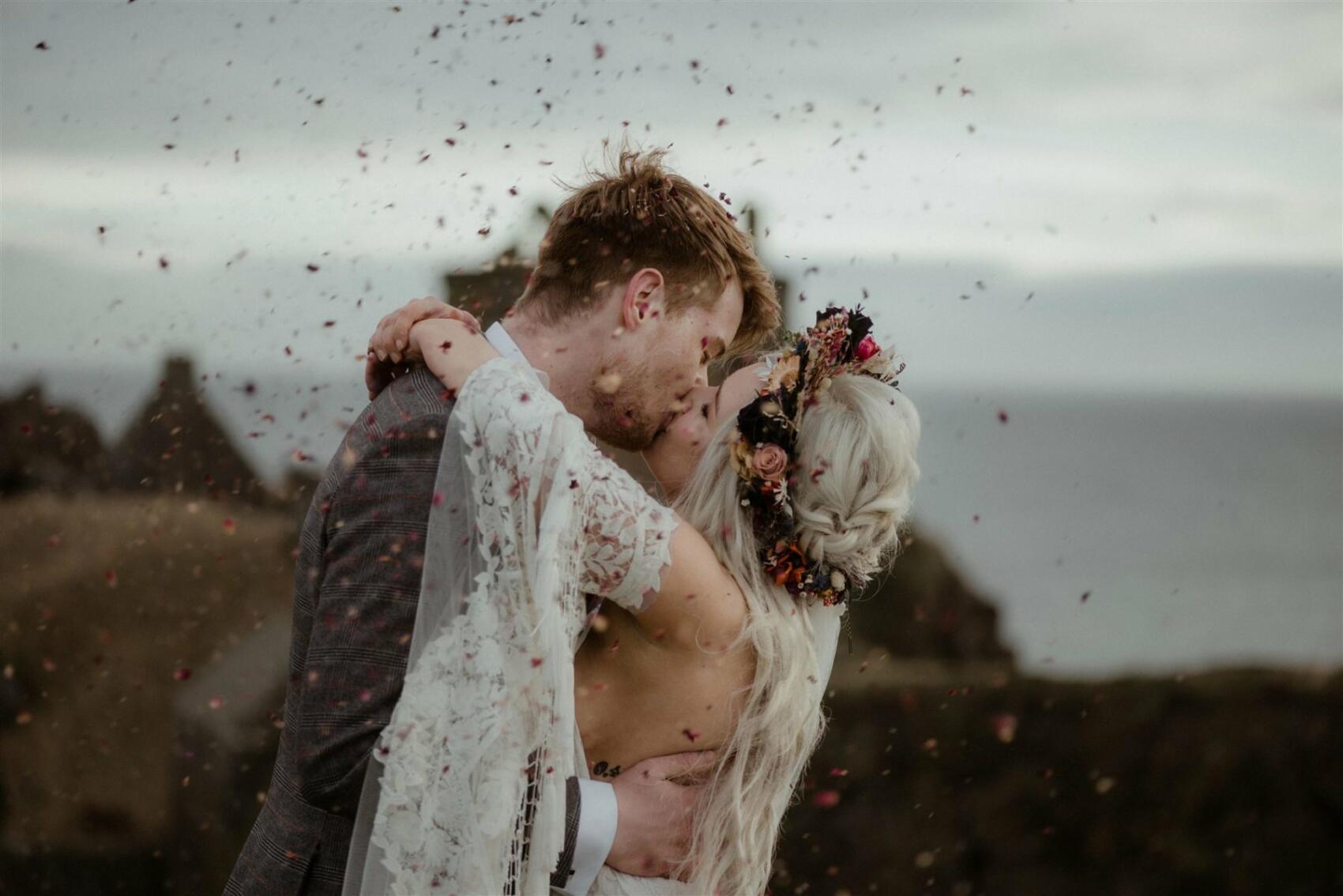 Bride and groom kiss with cobfetti at a Scottish elopement wedding