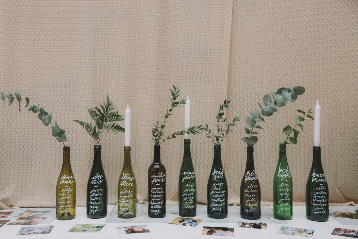 47 Recycled green bottles used as a wedding table plan