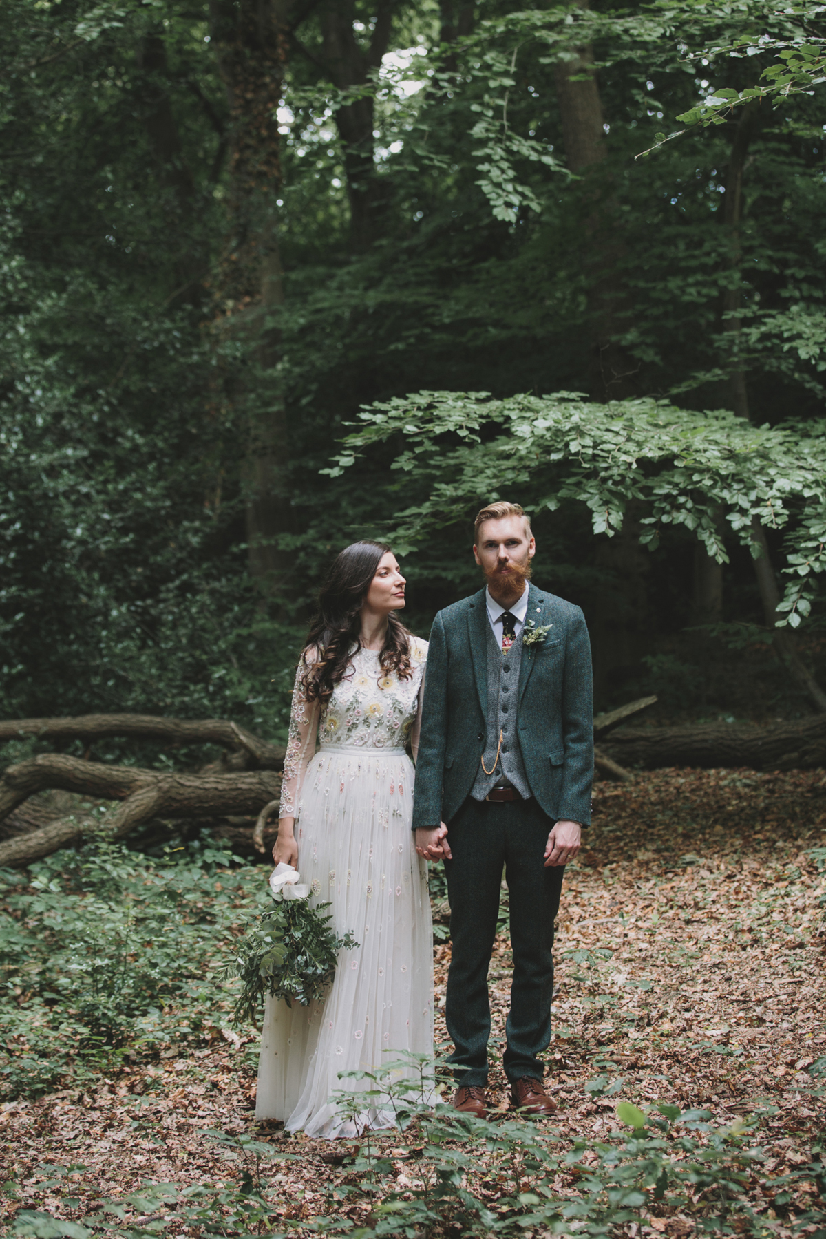 62 Bride in a Needle Thread gown and a Groom with a handlebar moustache and ASOS suit standing in woodland image by McKinley Rodgers