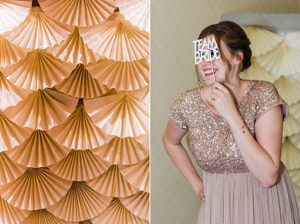 62 Deco fan wedding decor and bridesmaid in a sequin dress taking a selfie. Image by Sue Ann Taylor