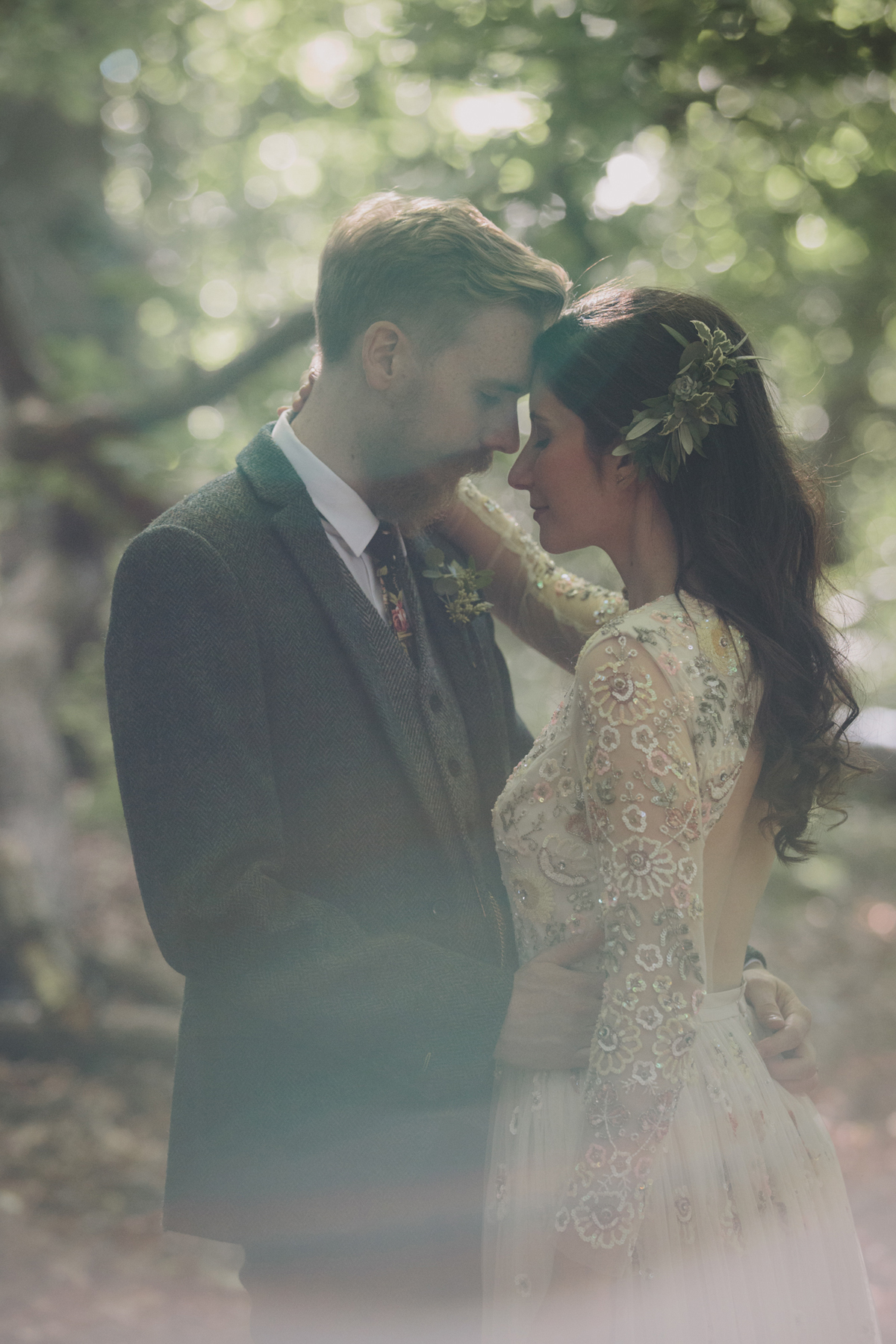 68 Bride in a Needle Thread gown and a Groom with a handlebar moustache and ASOS suit standing in woodland image by McKinley Rodgers