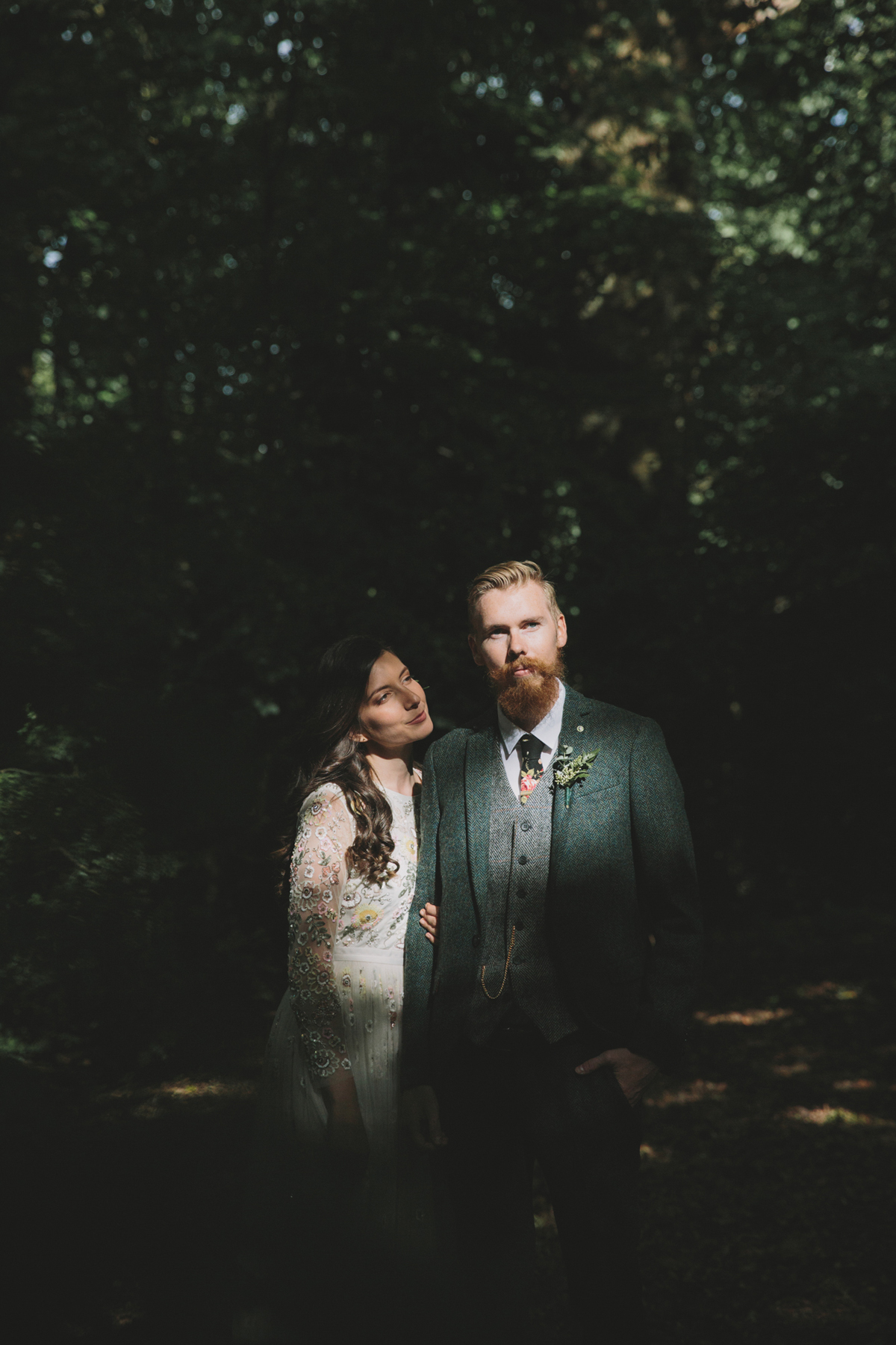 69 Bride in a Needle Thread gown and a Groom with a handlebar moustache and ASOS suit standing in woodland image by McKinley Rodgers