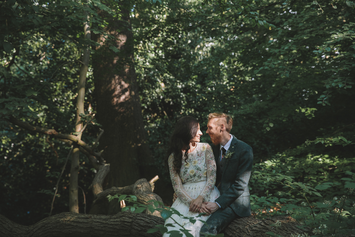 72 Bride in a Needle Thread gown and a Groom with a handlebar moustache and ASOS suit standing in woodland image by McKinley Rodgers
