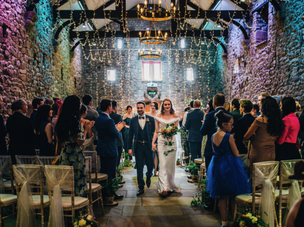 A Historic Tithe Barn Wedding with a bride wearing a Cowl Neck, Off-The-Shoulder Gown by The Couture Co.