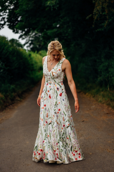 Bride wears bespoke multicoloured floral wedding dress by Rachel Lamb Design
