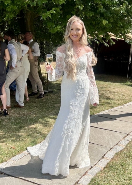Bride wears ivory lace off the shoulder bespoke wedding dress by Rachel Lamb Design