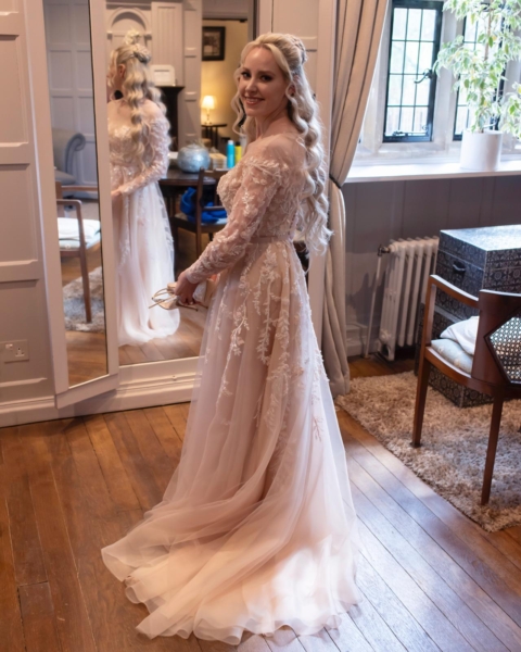 Bride wears pink tulle and lace beaded bespoke wedding gown