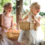 Two bridesmaids with baskets of rose petals