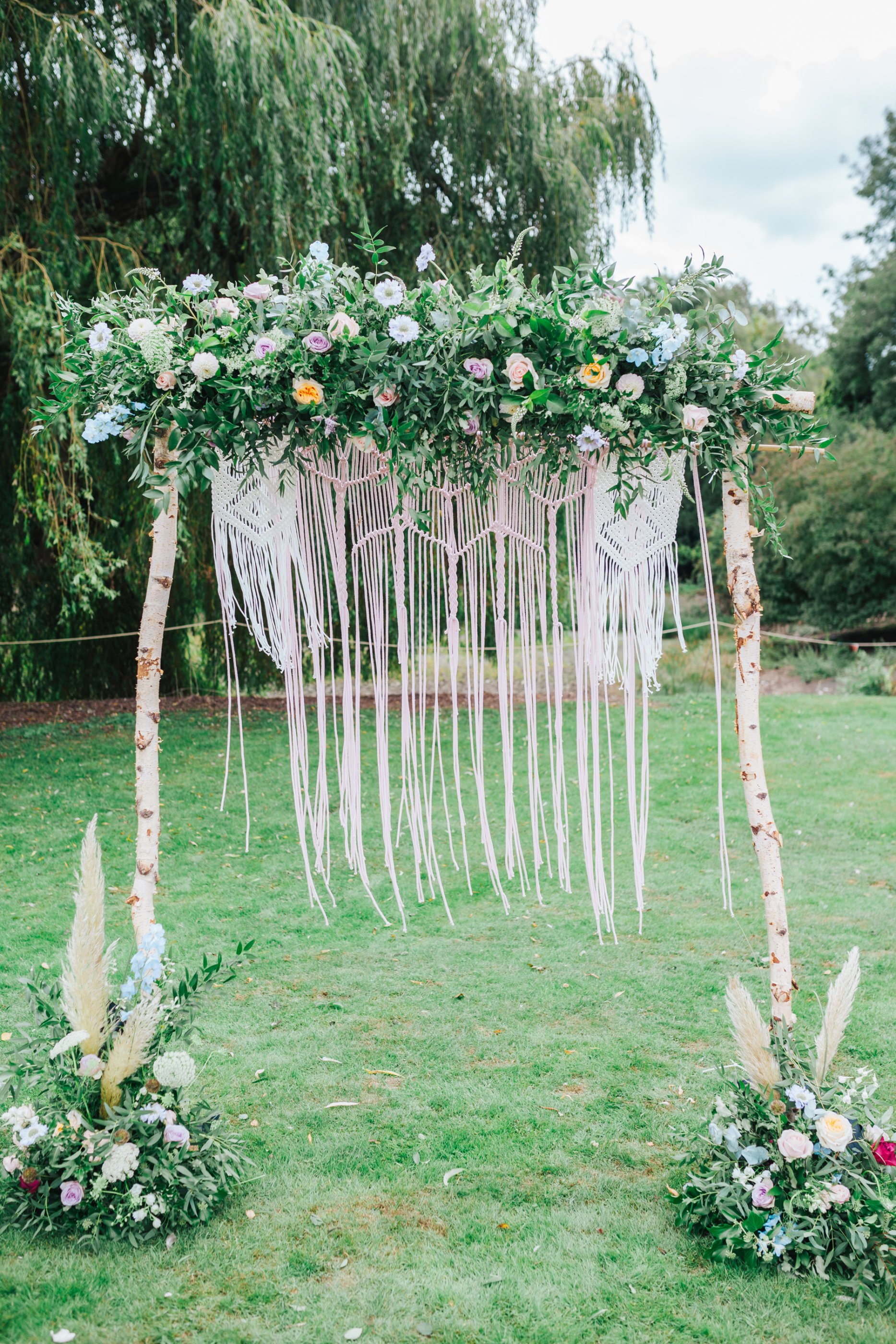 Boho outdoor wedding ceremony floral badkcrop with dreamcaters