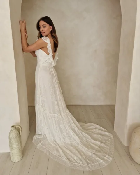 Model wearing a modern bohemian wedding dress.