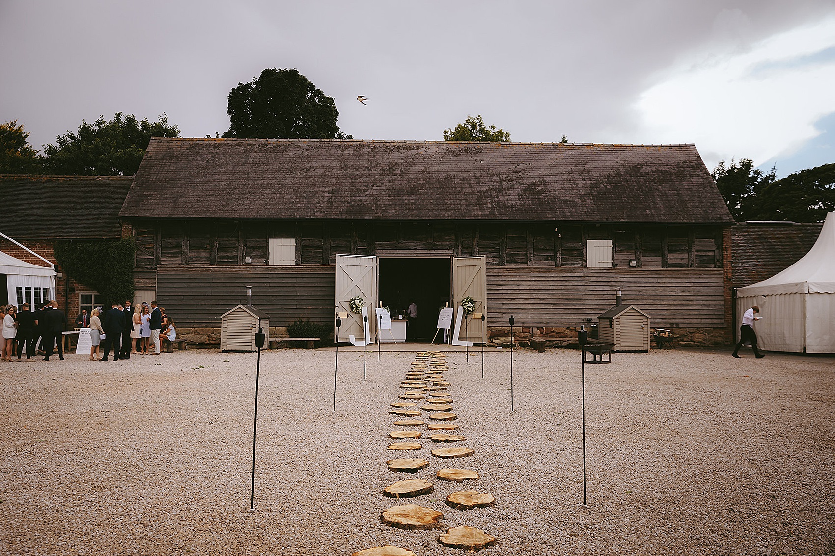 Elegant Caroline Castigliano bride  - A Caroline Castigliano Dress with a Lace Overskirt for a Contemporary Classic Black + Gold Barn Wedding