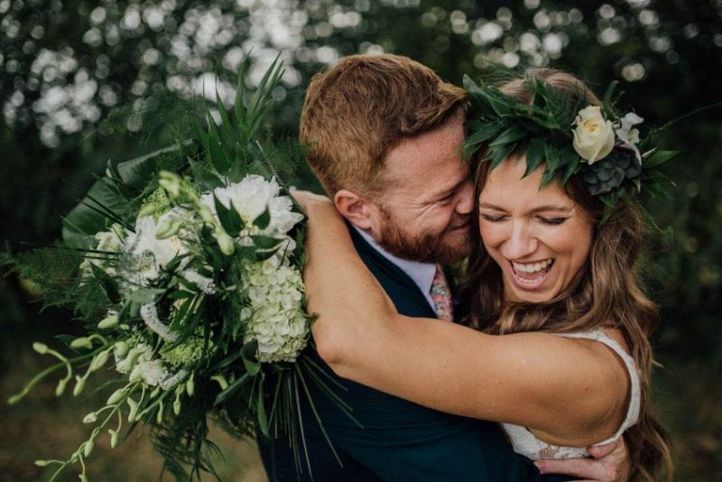 groom with bride holding a bouquet