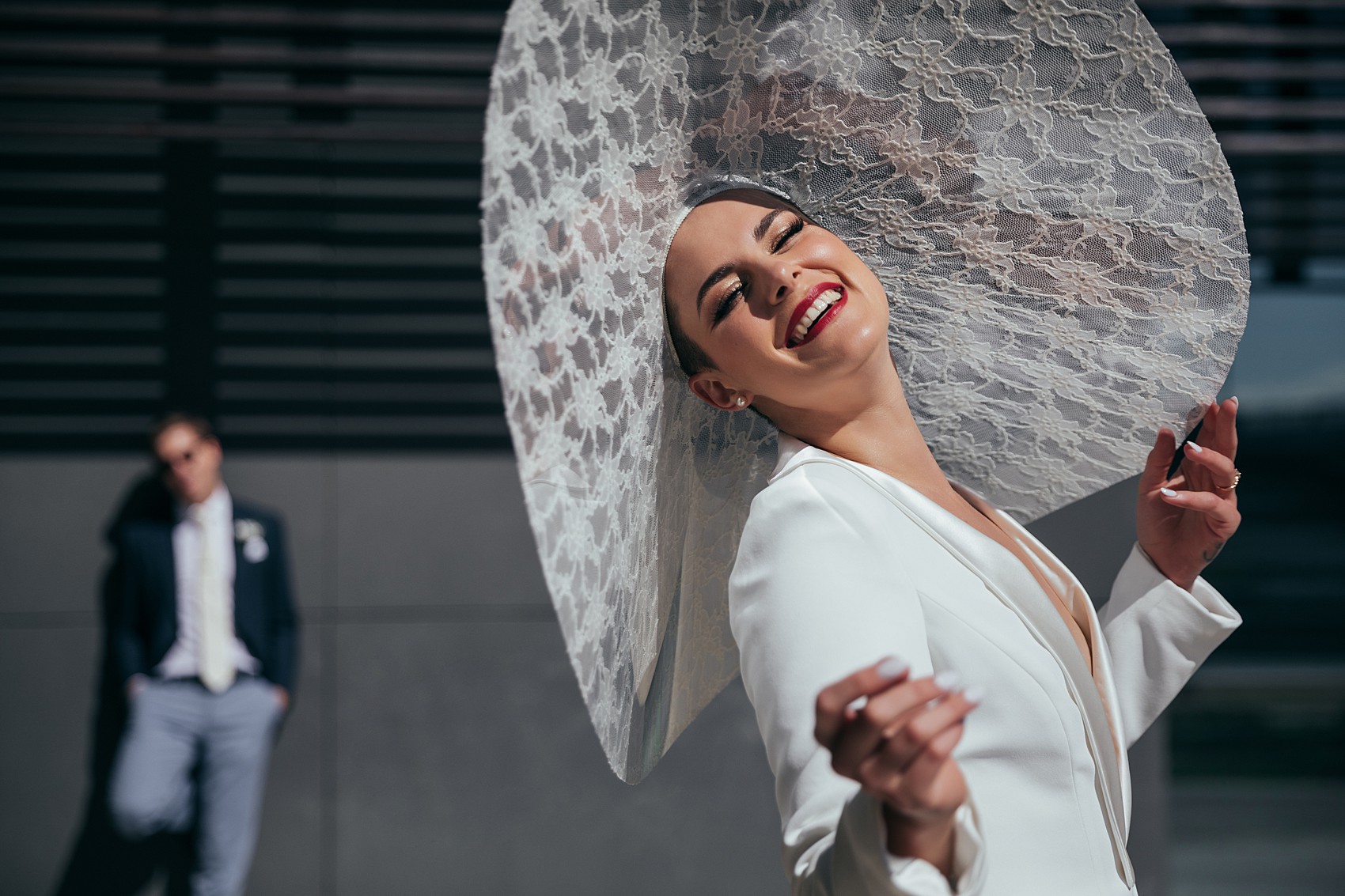 Bride in white tux oversizesd hat 12 1