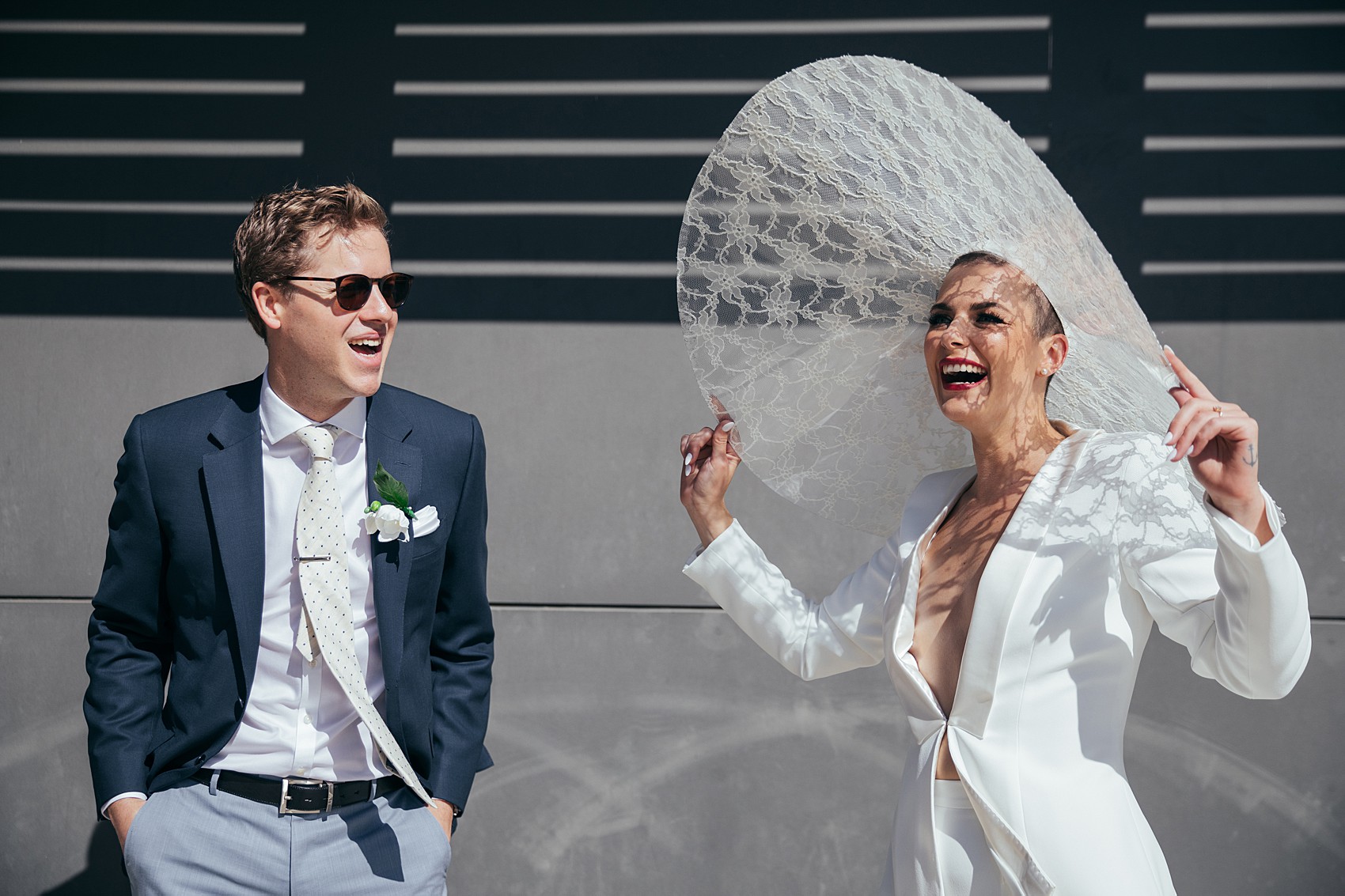 Bride in white tux oversizesd hat 13 1