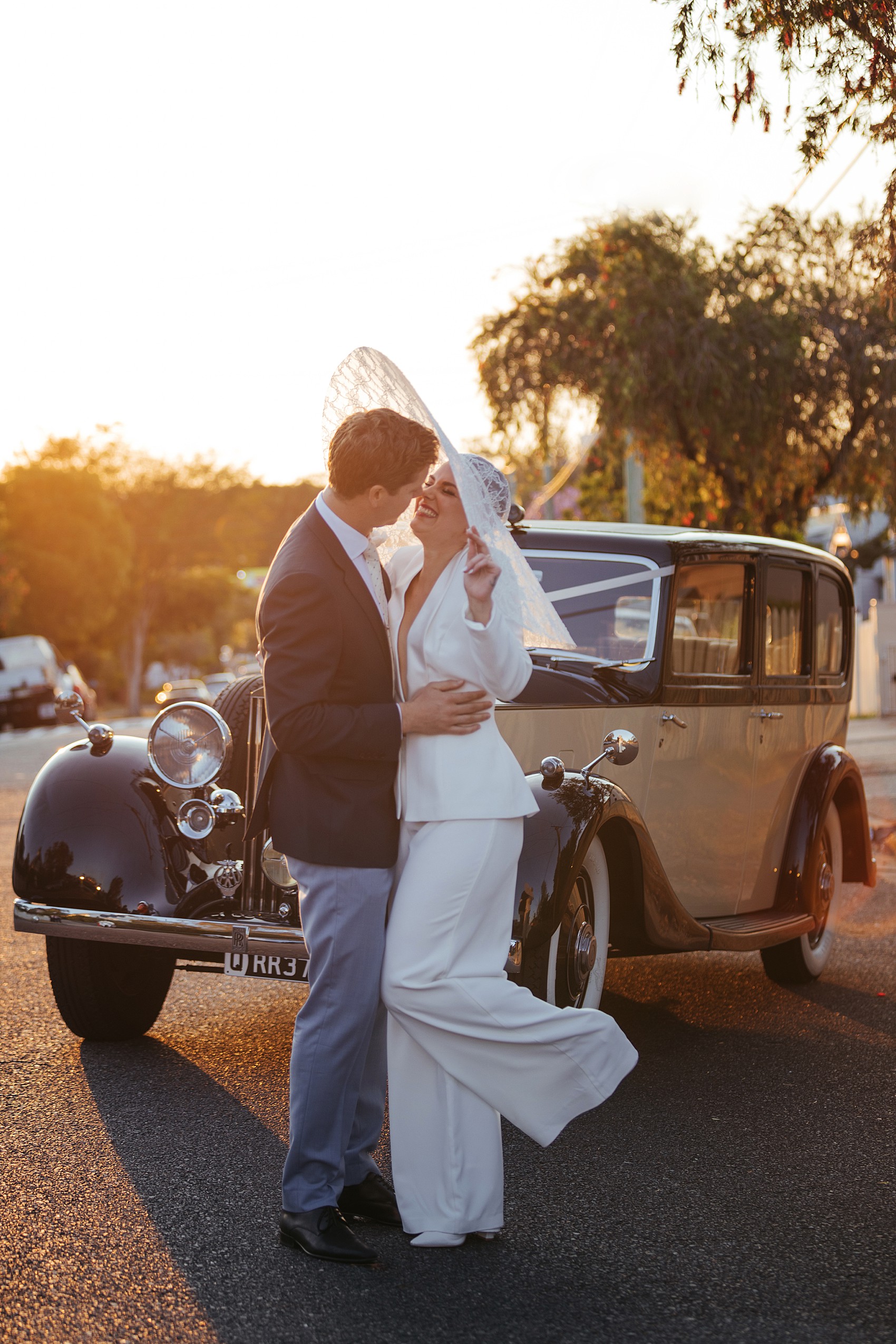 Bride in white tux oversizesd hat 22