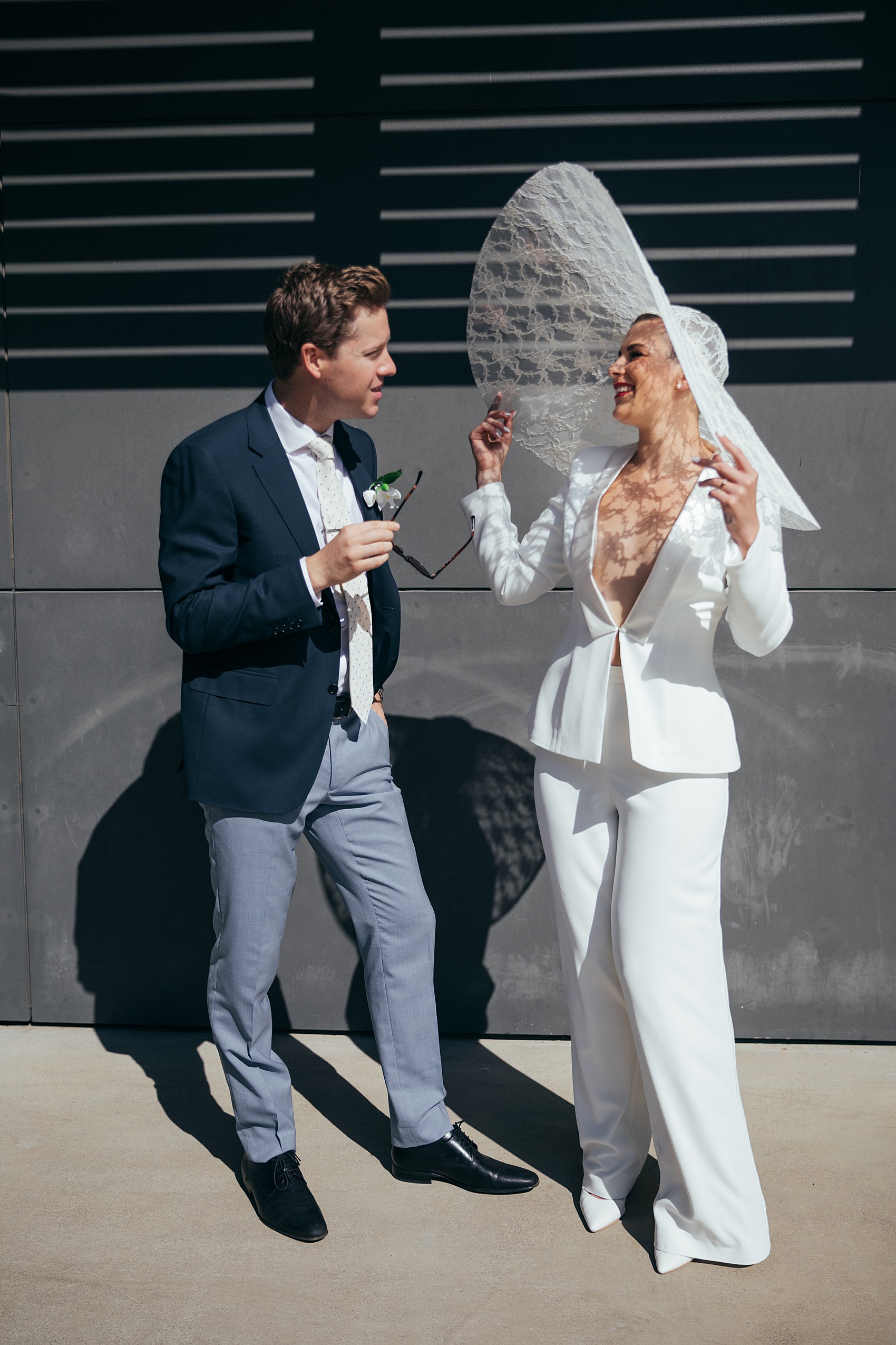 Bride in white tux oversizesd hat 45