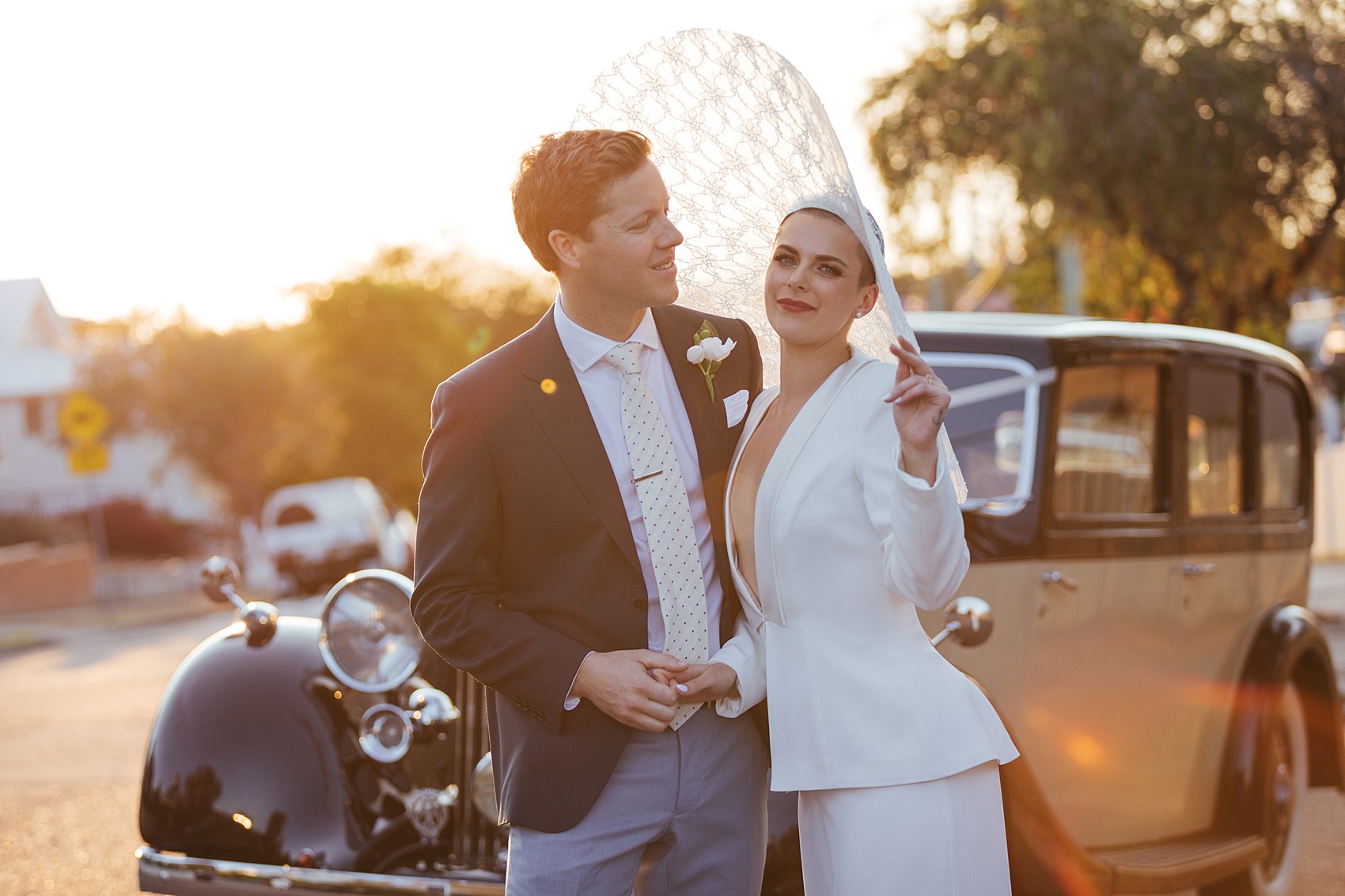 Bride in white tux oversizesd hat 51