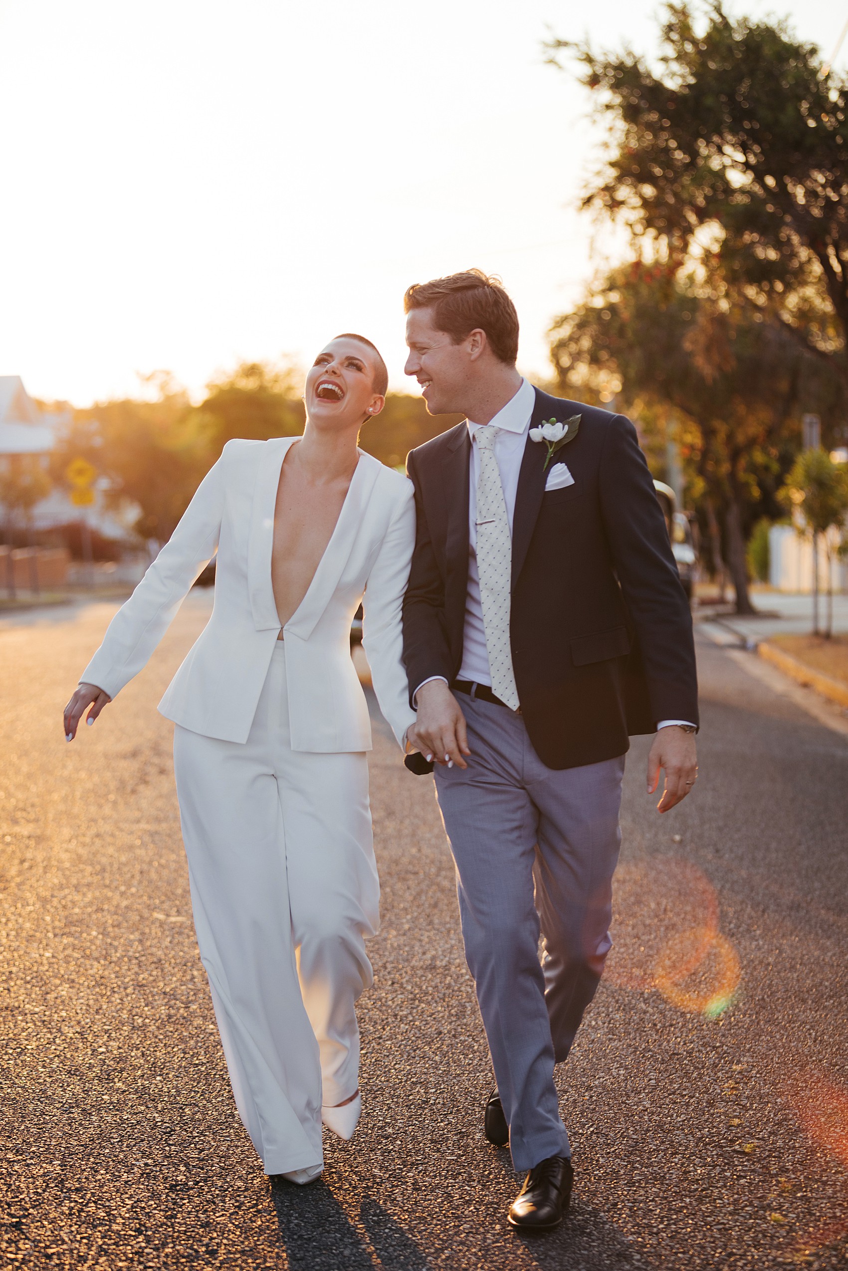 Bride in white tux oversizesd hat 52