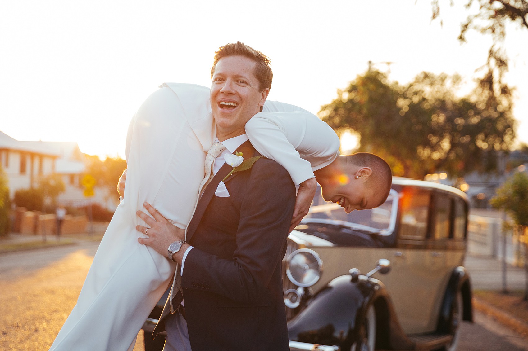 Bride in white tux oversizesd hat 74