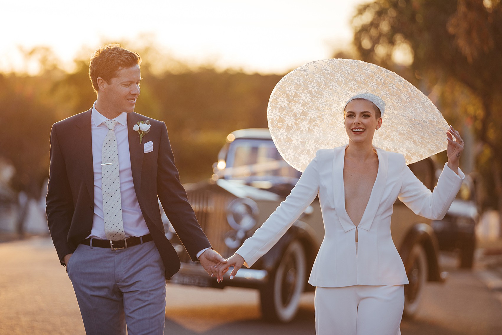 Bride in white tux oversizesd hat 76