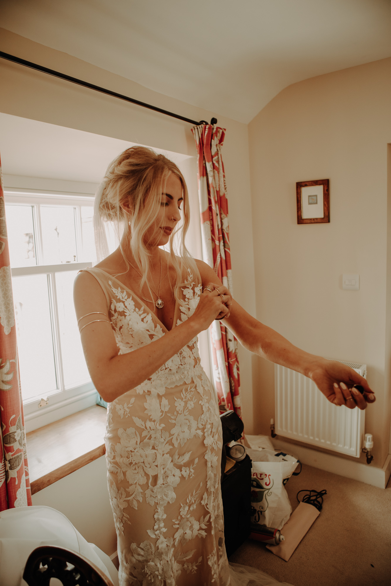 Bride applying perfume