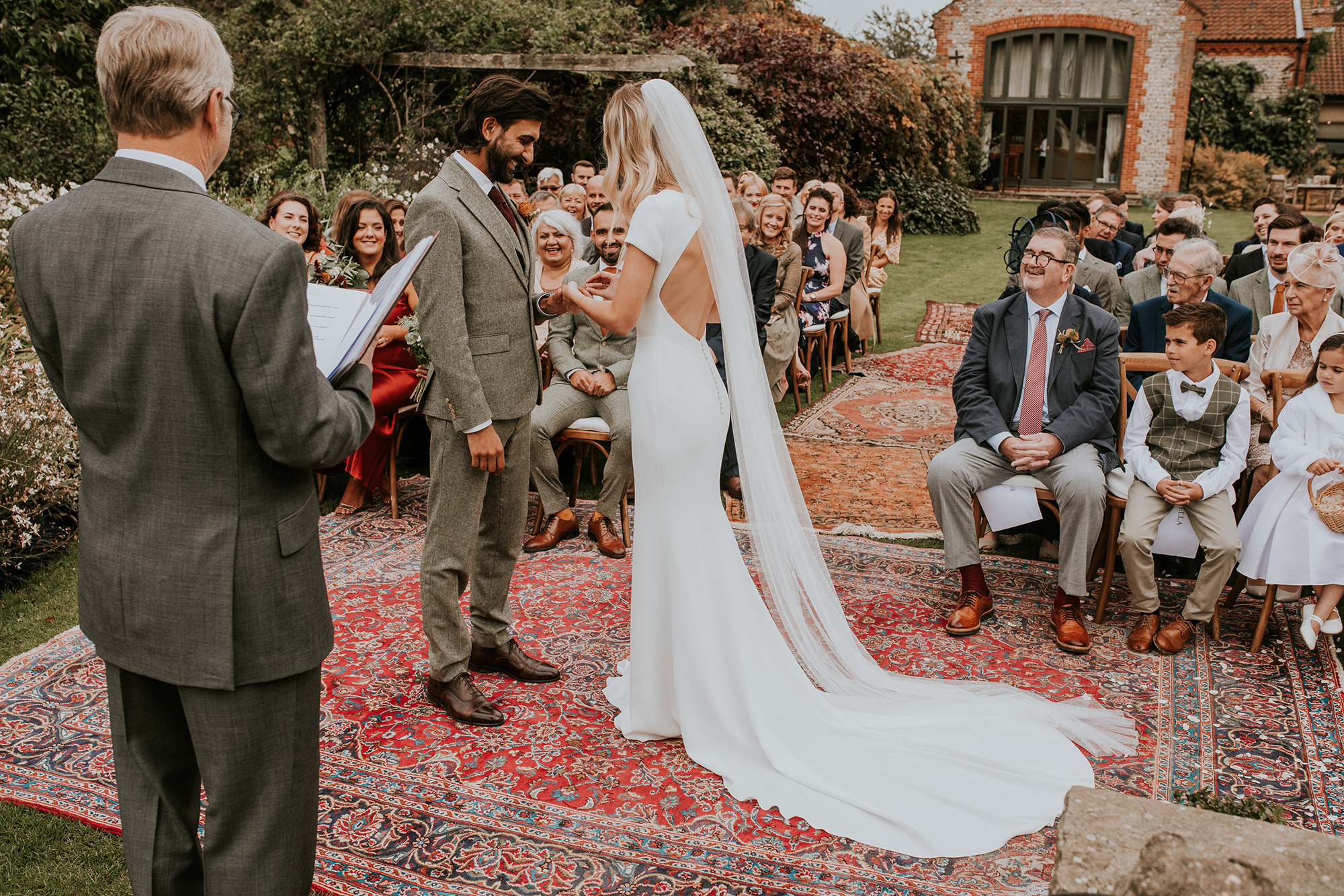 Backless Pronovias dress persian rugs outdoor wedding ceremony