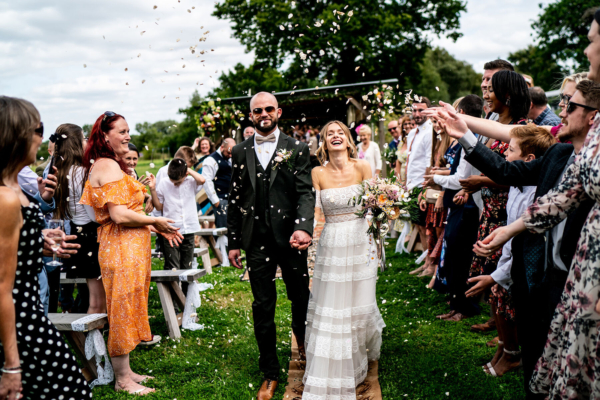 A Willowby by Watters Illusion Tulle Dress for a Laid Back Outdoor Wedding at The Fire Pit Camp in Norfolk