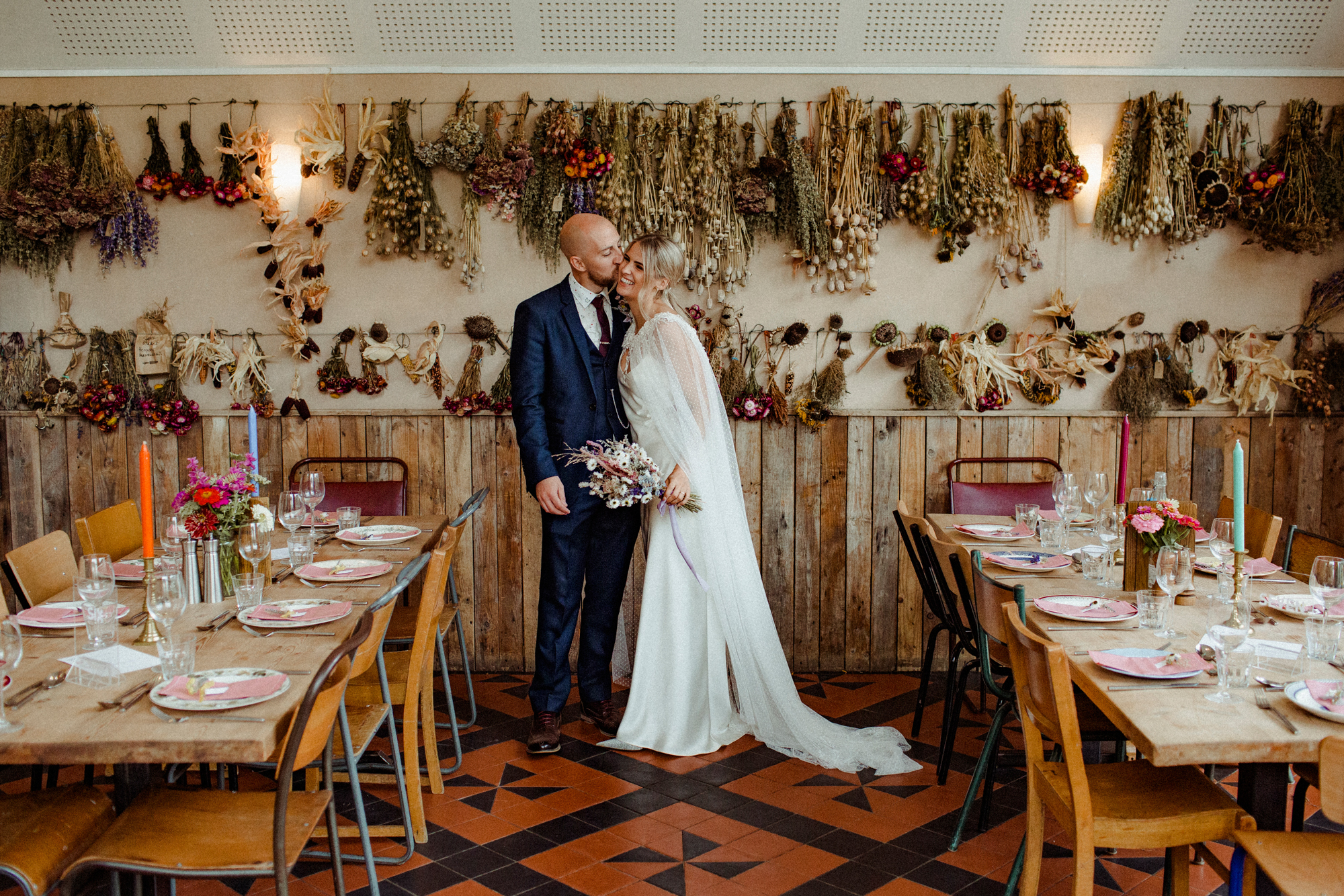 An Autumn Wedding at Riverford Field Kitchen in Devon, With Colourful Dried Flowers and a Bride in an Embroidered Halfpenny London Cape and Slip 30 Dried Hanging Flowers Riverford Field Kitchen wedding