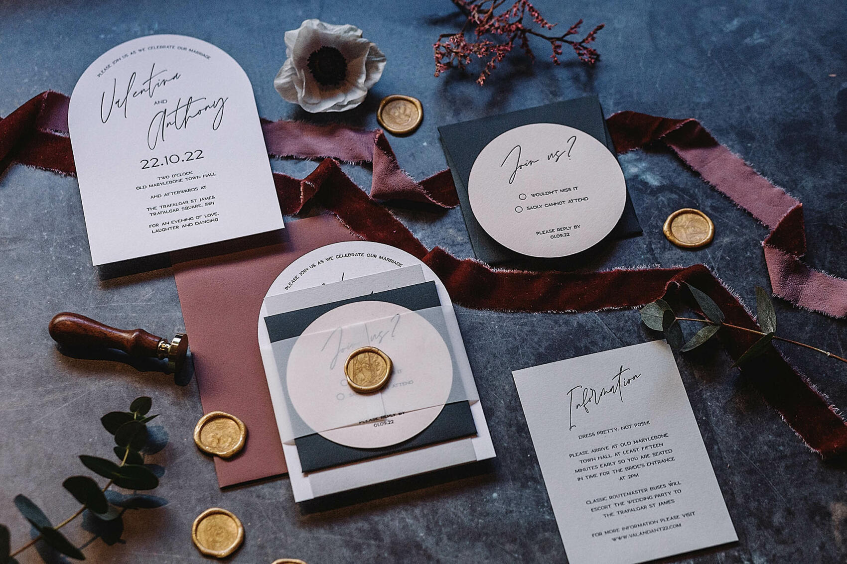 Luxury wedding invitation suite featuring arch shaped invitations with modern calligraphy, blush envelopes and gold wax seals