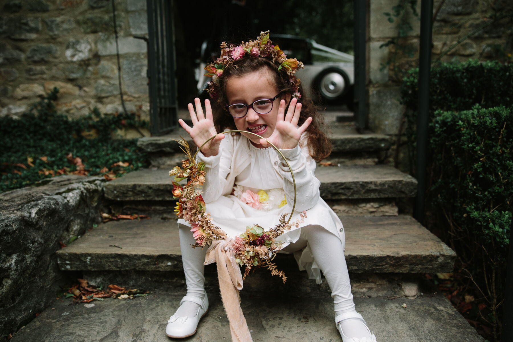 Cute flower girl with floral hoop