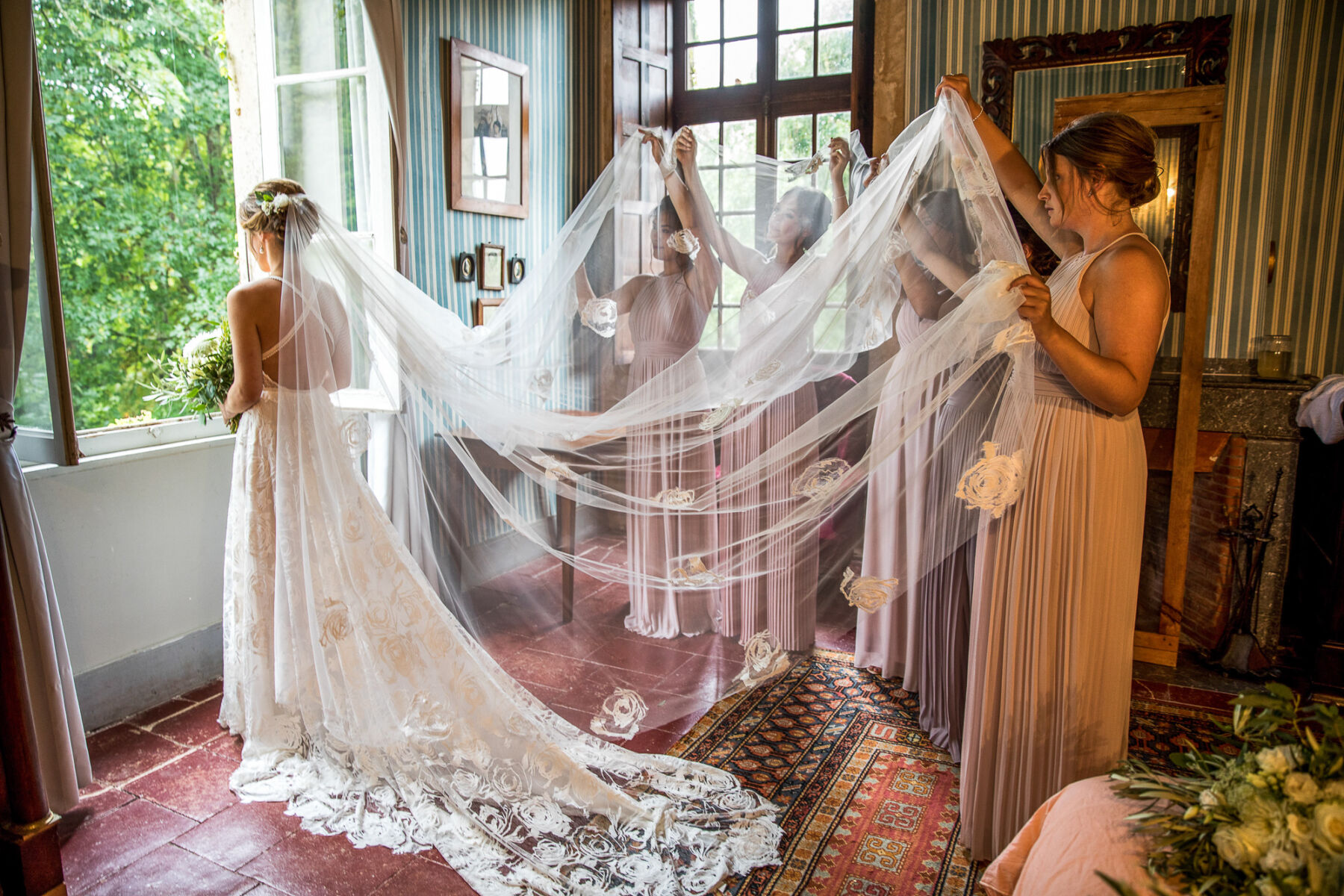 Bridesmaids holding the veil