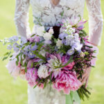 Bride holding a beautiful colourful bouquet at Pennard House wedding venue in Somerset