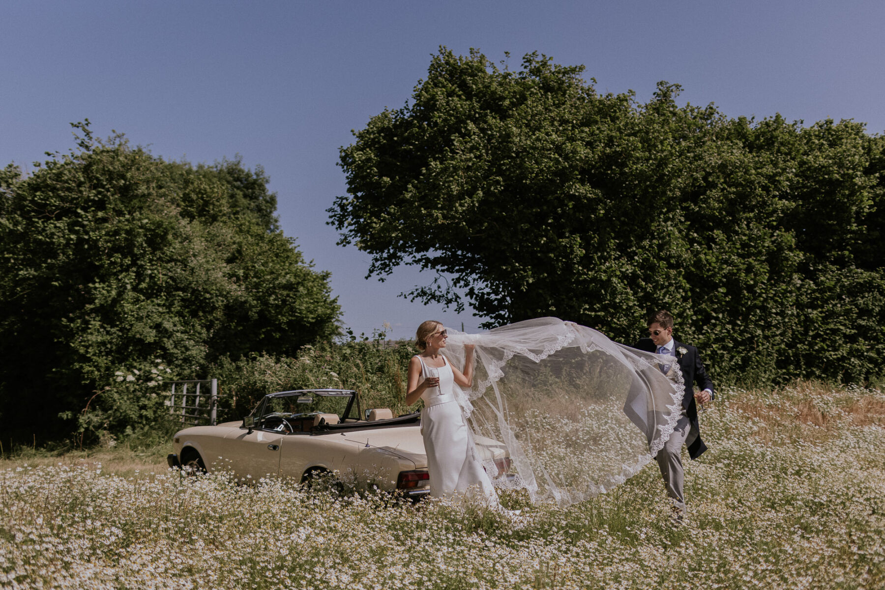 Wildflower meadow just married veil shot