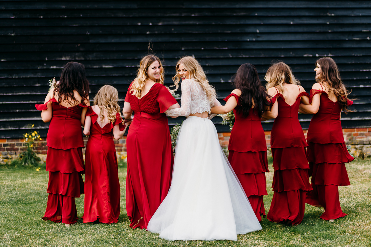 Bridesmaids in red dresses. Sandra Reddin Photography: London wedding photographer