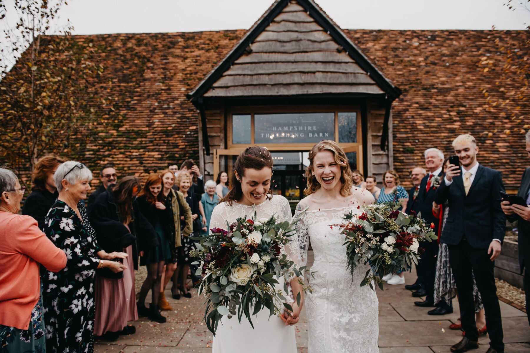 LGBTQ+ wedding - confetti time, newlywed brides at Silchester Farm wedding venue, Hampshire. Jessica Grace Photography.
