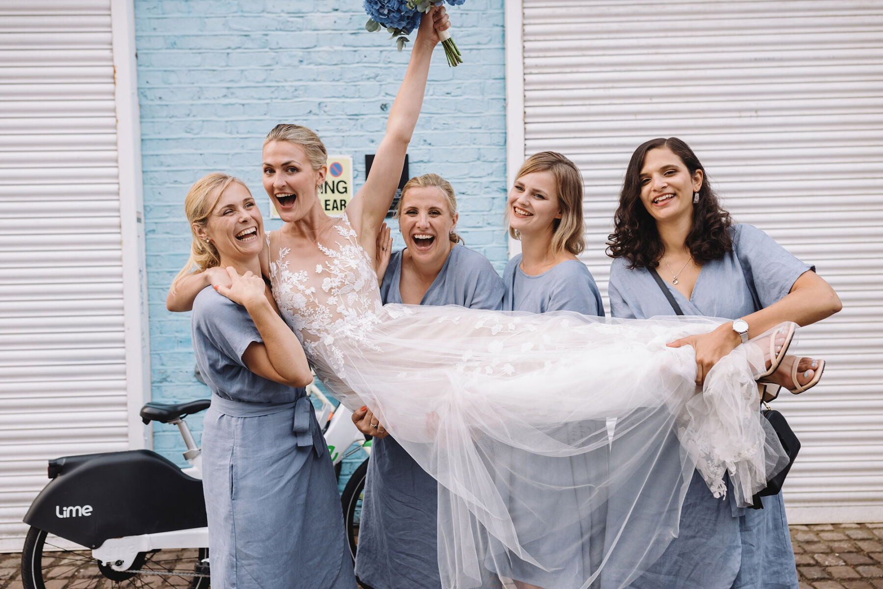 Bridesmaids lifting bride. Wolf & Co Photography.