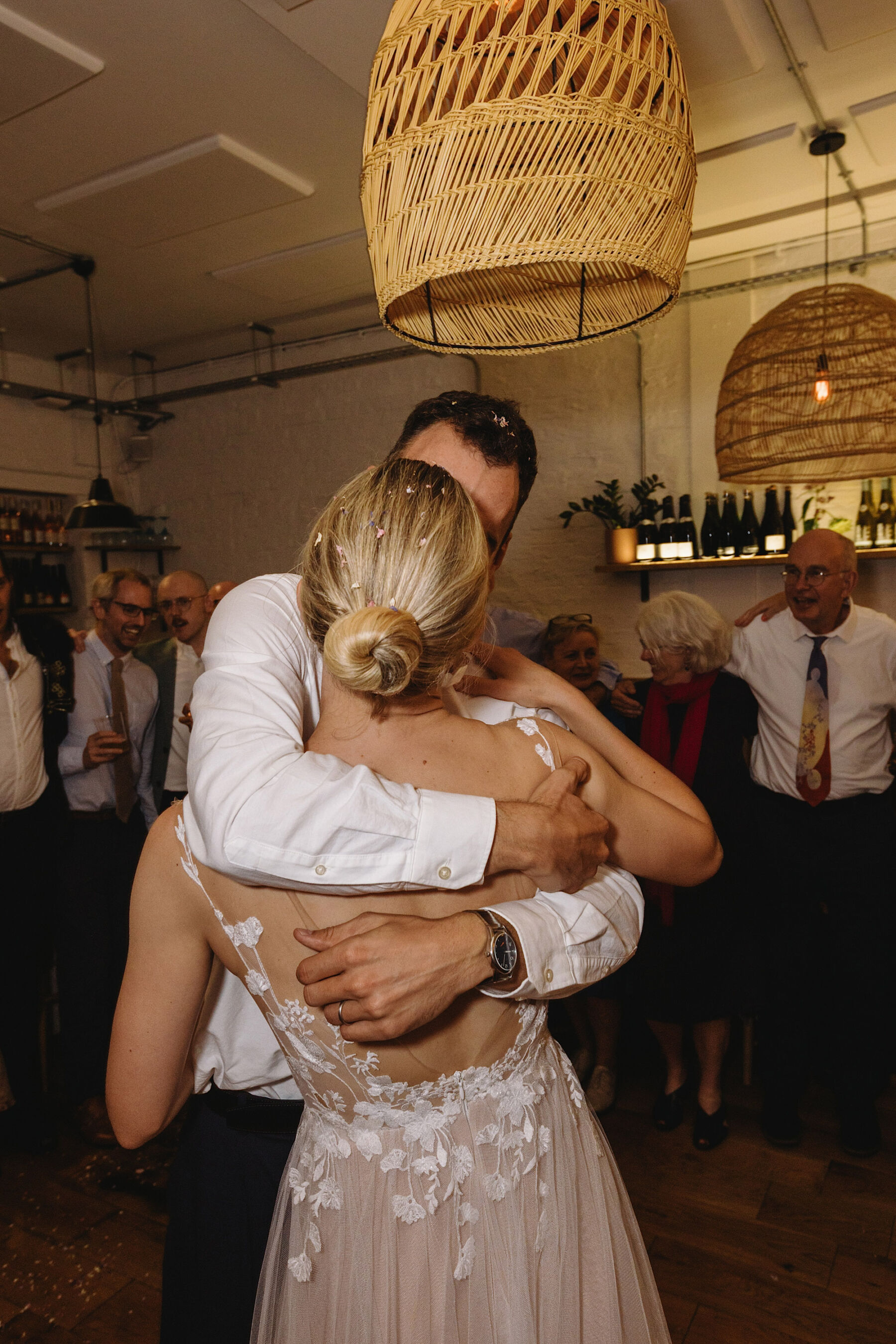 Anna Kara wedding dress. Groom embracing bride on the dance floor. Wolf & Co. Photography.