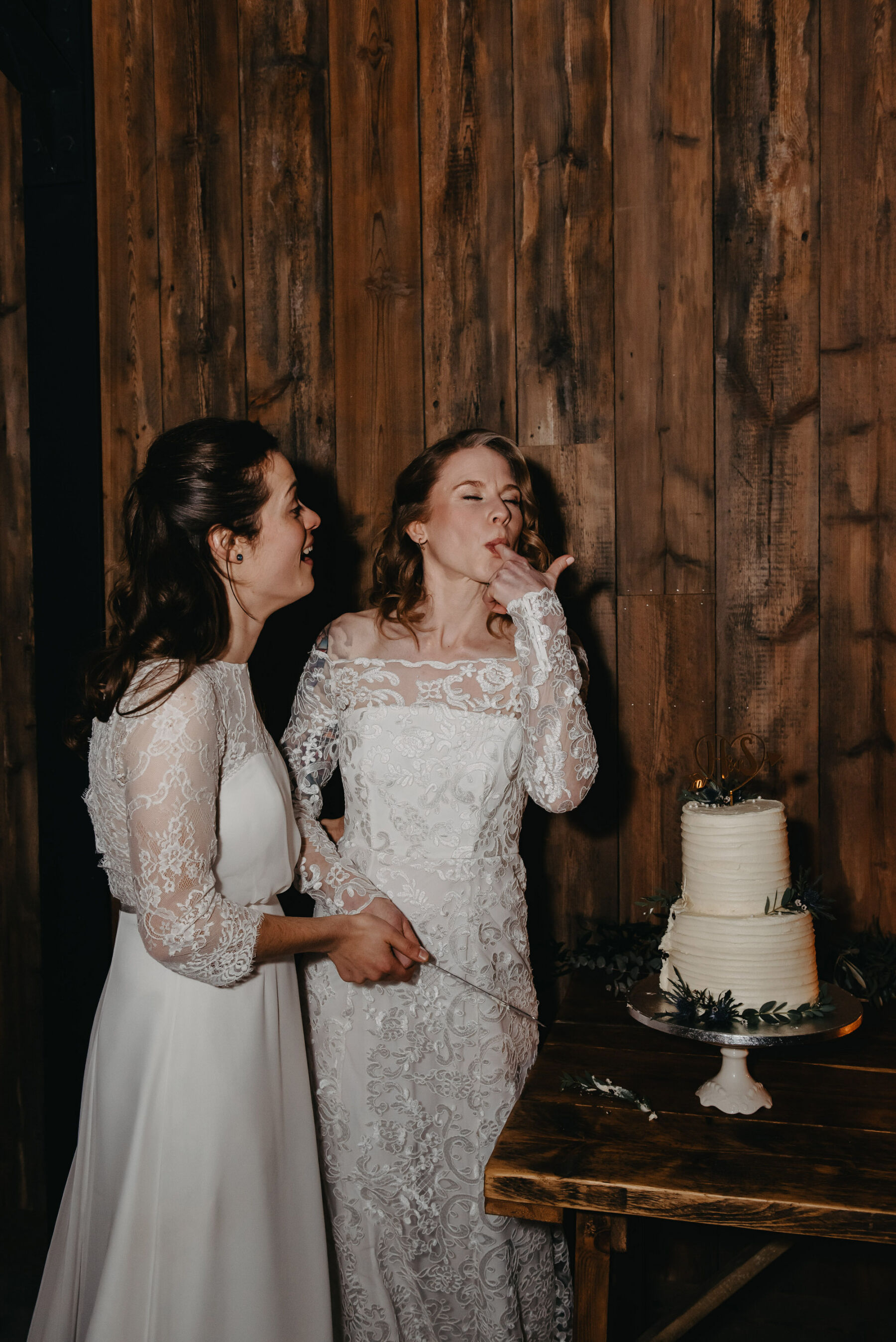 LGBTQ+ wedding - two brides cutting + tasting cake. Jessica Grace Photography.