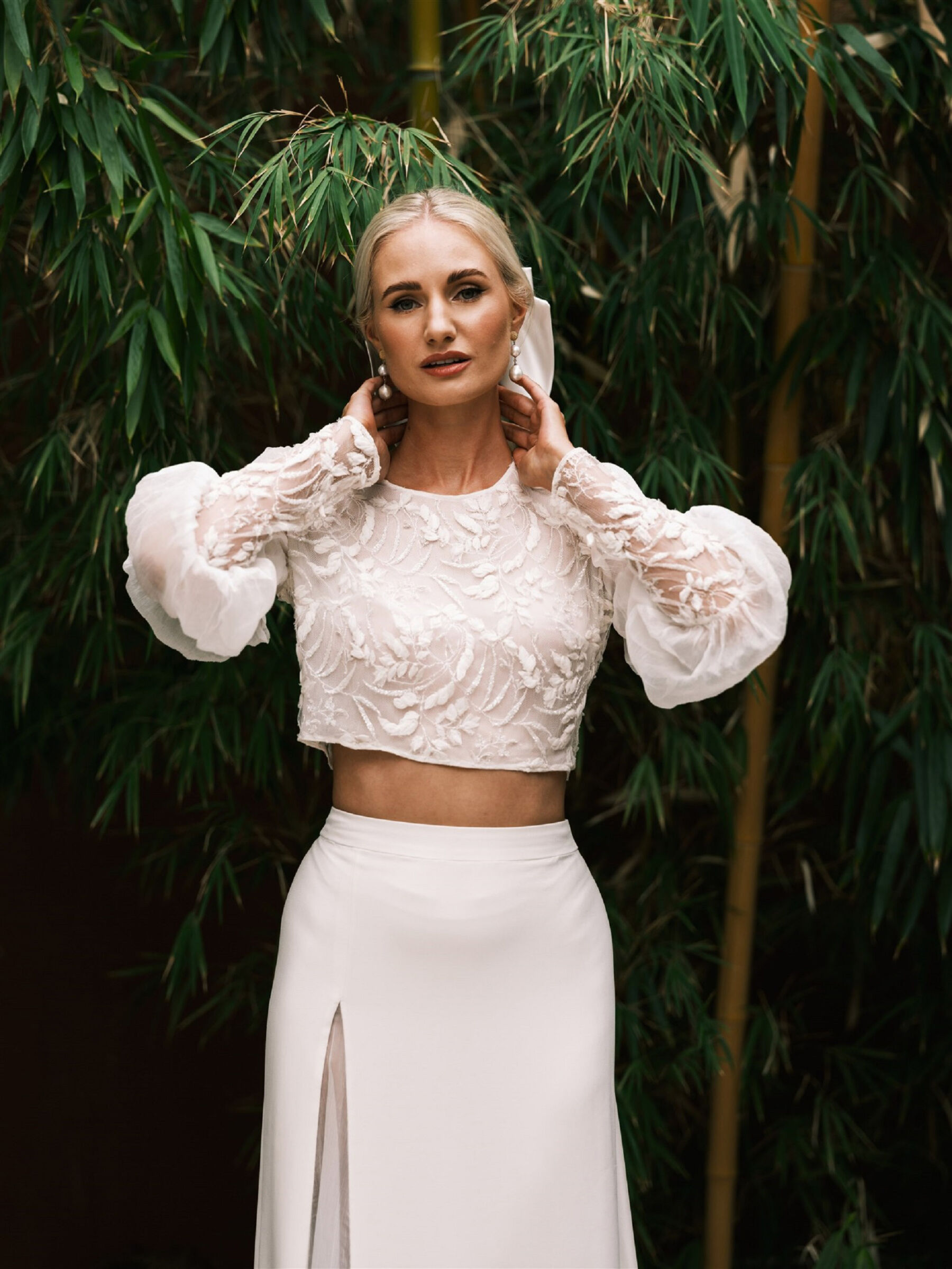 Caroline Takvorian wedding wedding skirt & crop top. Pearl earrings.