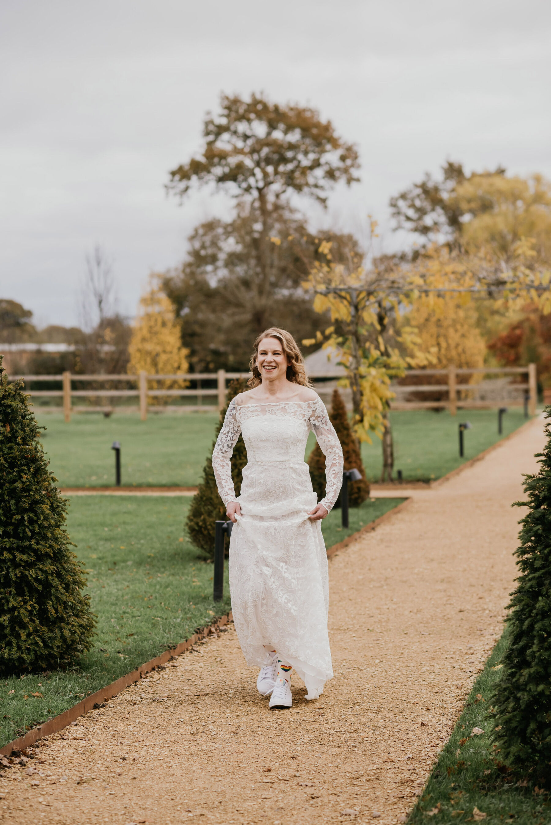 Bride in Converse and lace wedding dress. Jessica Grace Photography.