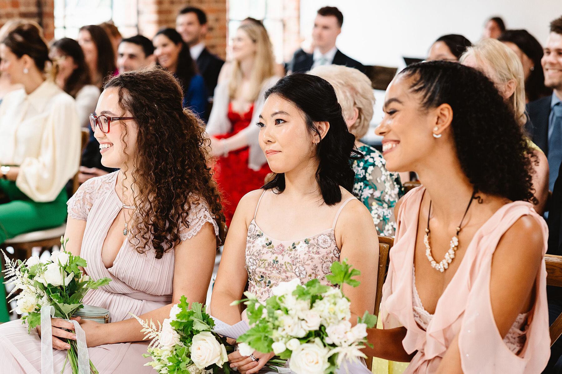Bridesmaids in pastel pink dresses.
